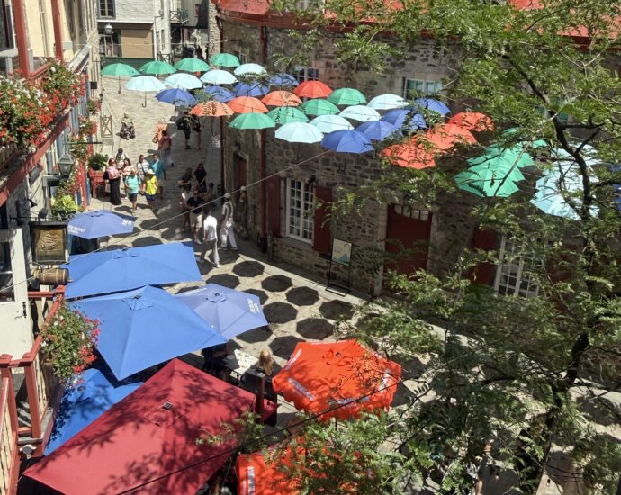 Colorful umbrellas suspended above Rue du Cul-de-Sac in Quebec City's Lower Town