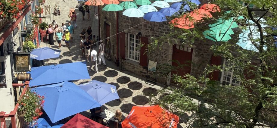 Colorful umbrellas suspended above Rue du Cul-de-Sac in Quebec City's Lower Town