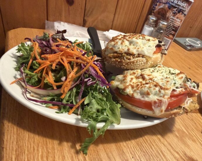 Bagel sandwich with melted cheese and a side salad at Bügel Fabrique de Bagels in Montcalm, Quebec City