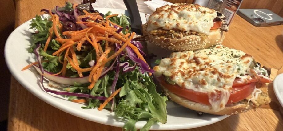 Bagel sandwich with melted cheese and a side salad at Bügel Fabrique de Bagels in Montcalm, Quebec City