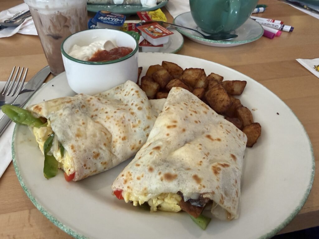 Cora crêpe burrito with eggs, vegetables, black bean patty, potatoes, salsa and sour cream in Quebec City