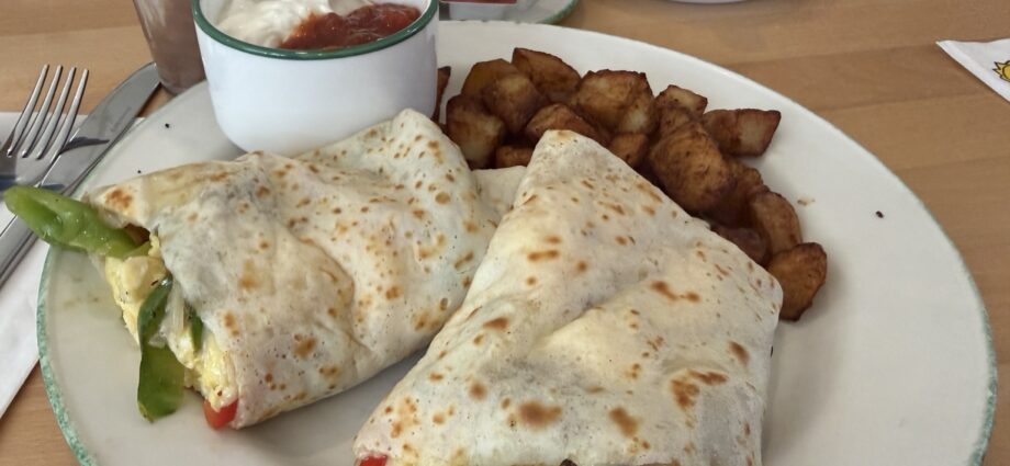 Cora crêpe burrito with eggs, vegetables, black bean patty, potatoes, salsa and sour cream in Quebec City